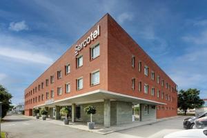 a large red brick building with a sign on it at Sercotel Sant Boi in Sant Boi del Llobregat +38 photos