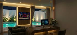 a living room with a couch and a table with a television at Anantita Poolside Boutique in Phra Nakhon Si Ayutthaya