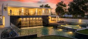a house with a swimming pool in front of a house at Anantita Poolside Boutique in Phra Nakhon Si Ayutthaya