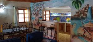 a kitchen with a table and chairs and a mirror at Villa Les Flamboyants in Somone
