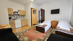 a living room with two beds and a kitchen at Keja II in Łeba