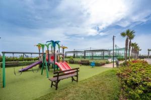 a park with a playground with a slide and a bench at Modern Apartment with Pool & Sea View in Casablanca