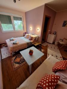a bedroom with a bed and a table and a couch at Nensi in Mostar