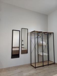 a room with three mirrors and a shelf with towels at Medea Suites Apartamentos in Mérida +34 photos