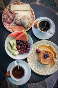 a table with plates of food and cups of coffee at Hotel 't Paviljoen in Rhenen
