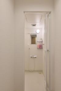 a white bathroom with a shower and a toilet at AO Odawara Lounge in Odawara +40 photos