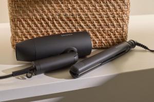 a black hairdryer sitting on a shelf next to a basket at AO Odawara Lounge in Odawara