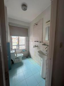 a bathroom with a sink and a tub and a toilet at Om Tara Guest House Pvt Ltd in Kathmandu