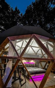 a tent with a bed inside of it at Dôme Bao SPA luxe climatisé in Lesterps