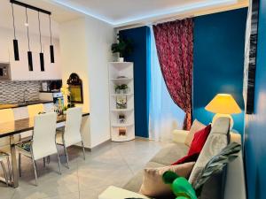 a living room and kitchen with a couch and a table at Nice apartment in the historic center in Verbania