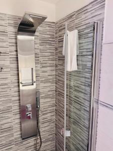 a bathroom with a shower with a mirror and a towel at Nice apartment in the historic center in Verbania +57 photos