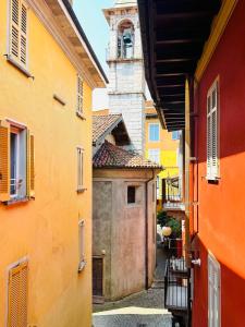 an alley with a building with a clock tower at Nice apartment in the historic center in Verbania