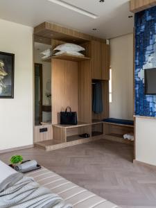 a room with a bed and a tv in it at Hotel Serenity Suites in Nagpur