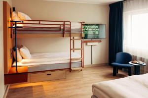 a room with two bunk beds and a chair at Scandic Go, Eerikinkatu 30 in Turku