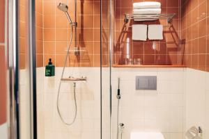 a shower with a glass door in a bathroom at Scandic Go, Eerikinkatu 30 in Turku