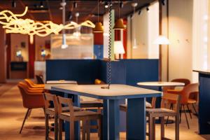 a group of tables and chairs in a restaurant at Scandic Go, Eerikinkatu 30 in Turku +8 photos