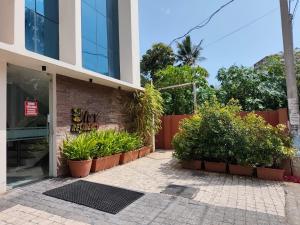 a building with plants in front of a building at IVY RESIDENCY in Trivandrum