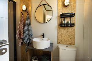 a bathroom with a sink and a mirror and a toilet at Camping Magali Plage in Liourdres +29 photos