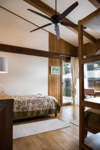 a bedroom with a bed and a ceiling fan at Villa Nataly at Golf Resort in Bansko