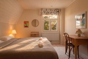 a bedroom with a bed and a desk and a window at Stay North - Marjaniemi in Salo
