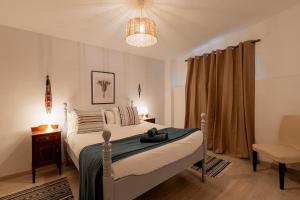 a bedroom with a bed and a chair in it at Orotava The Home - Vacational rental with the lifestyle of 1700 and the comfort of 2022 in La Orotava
