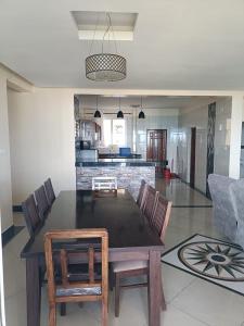a kitchen and dining room with a table and chairs at Emirates in Mombasa