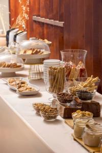 a buffet with various desserts and other food on a table at Porto Skala Village Hotel in Skala