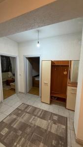an empty room with a kitchen and a living room at Coolbnb Apartment Tetovo in Tetovo