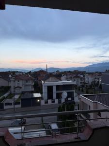 a view from the balcony of a city at dusk at Coolbnb Apartment Tetovo in Tetovo