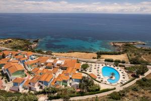 an aerial view of a resort with a swimming pool at Porto Skala Village Hotel in Skala