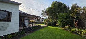 a backyard of a house with a grass yard at Point Wells Village Bach in Omaha