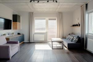 a living room with a couch and a table at Apartamenty 107 in Rumia