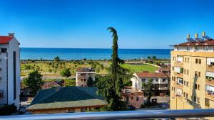 a view of a city with a palm tree at Trabzon Zingila Residence in Yomra