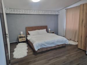 a bedroom with a bed and two night stands at Casa Florentina in Făgăraş