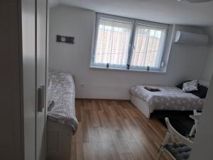 a small room with a bed and a window at Werner Apartman in Mohács