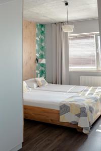 a bedroom with a large bed in a room at Apartamenty 107 in Rumia