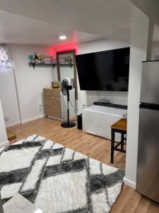 a room with a bedroom with a bed and a television at Cozy Broadway in Minneapolis