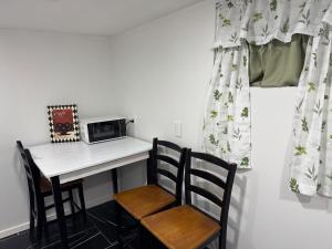 a kitchen with a table and two chairs and a microwave at Cozy Broadway in Minneapolis