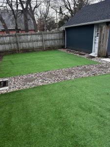 a backyard with green grass and a fence at Cozy Broadway in Minneapolis