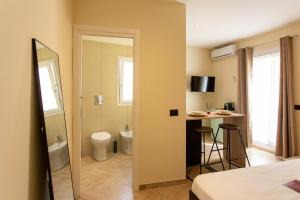 a room with a bathroom with a toilet and a sink at L'ateneo Lumiére in Agrigento +41 photos