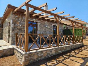 a wooden pergola build on a stone house at Alyki Stone House 4 in Alyki