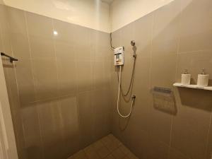 a shower stall with a phone in a bathroom at SKYPEARL Guesthouse & Café in Ko Tao
