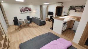 a living room with a kitchen and a dining room at Sunrise House in Žilina