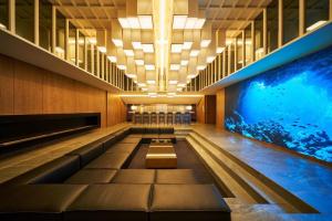 a swimming pool in a building with a aquarium at The Blue House in Katsuura