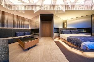 a bedroom with a large bed and a couch at The Blue House in Katsuura