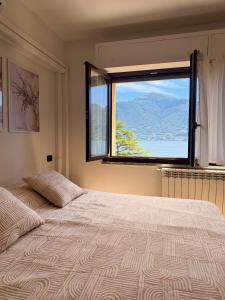 a bedroom with a large bed with a large window at 2-Bedroom Airconditioned Lakeview Apartment in Acquaseria