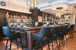 a bar with a row of chairs around it at Meiser Altstadt Hotel in Dinkelsbühl