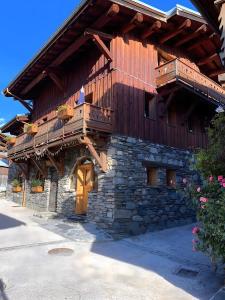 a wooden building with a balcony on it at Le Génépi in La Plagne Tarentaise