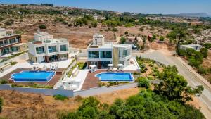 an aerial view of a house with two swimming pools at Love Bridge Seaview Villas in Ayia Napa