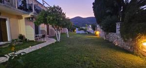 a yard of a house with a building at Το Είδωλον Sea Maisonettes & Studio in Ancient Epidauros
